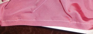 Guideline stitch shown from the wrong side of the fabric, and ribbon pinned to the right side