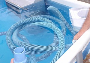 filling the swimming pool vacuum tube with water
