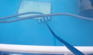 roller base attached to swimming pool vacuum tubing