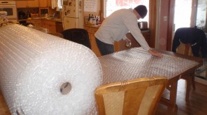 a young engineer at work with bubble wrap