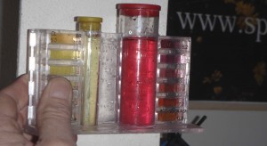 pH of pool water (on right) is compared to permanent color chart that comes with test kit