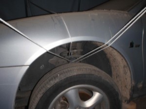 how to tie a portable garage to a Ford Taurus under the tires