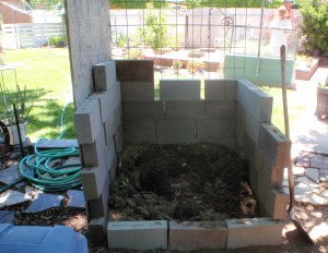 a simple stacked brick compost bin