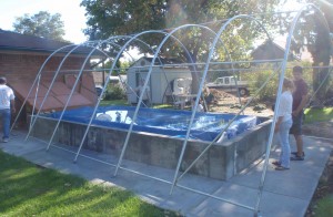 The frame of our portable instant garage, now swimming pool, cover has just been put in place over the pool.