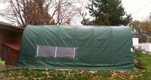 portable garage used as winter cover for outdoor swimming pool so that it can be used comfortably during the cold months.