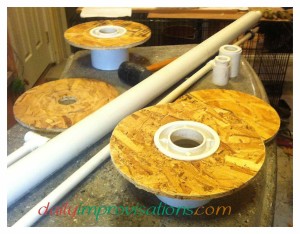All the pieces; the 1 1/4 diameter PVC pipe is already inside of the 2 inch PVC pipe; the larger coupler will go over the end of the 2 inch pipe extending out past the large spool; the smaller coupler will go into the inner circle of the outer circle of wood.