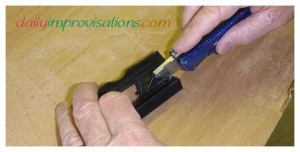 The shop knife cuts through the last thin layer of plastic easily.