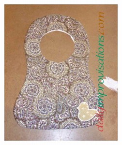 The paisley side of the bib after the outer edges have been sewn and the bib is turned right sides out.