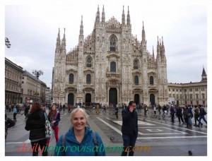 The massive cathedral, or duomo, in the center of Milan has a wide plaza around it, but you can see the buildings off to the side disappear into narrower streets, and those buildings are fairly flat and colorless.