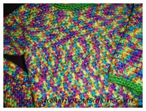 The transition between the two stitch patterns in this children's crocheted sweater are subtle and blended together even more by the constantly changing color in the yarn.