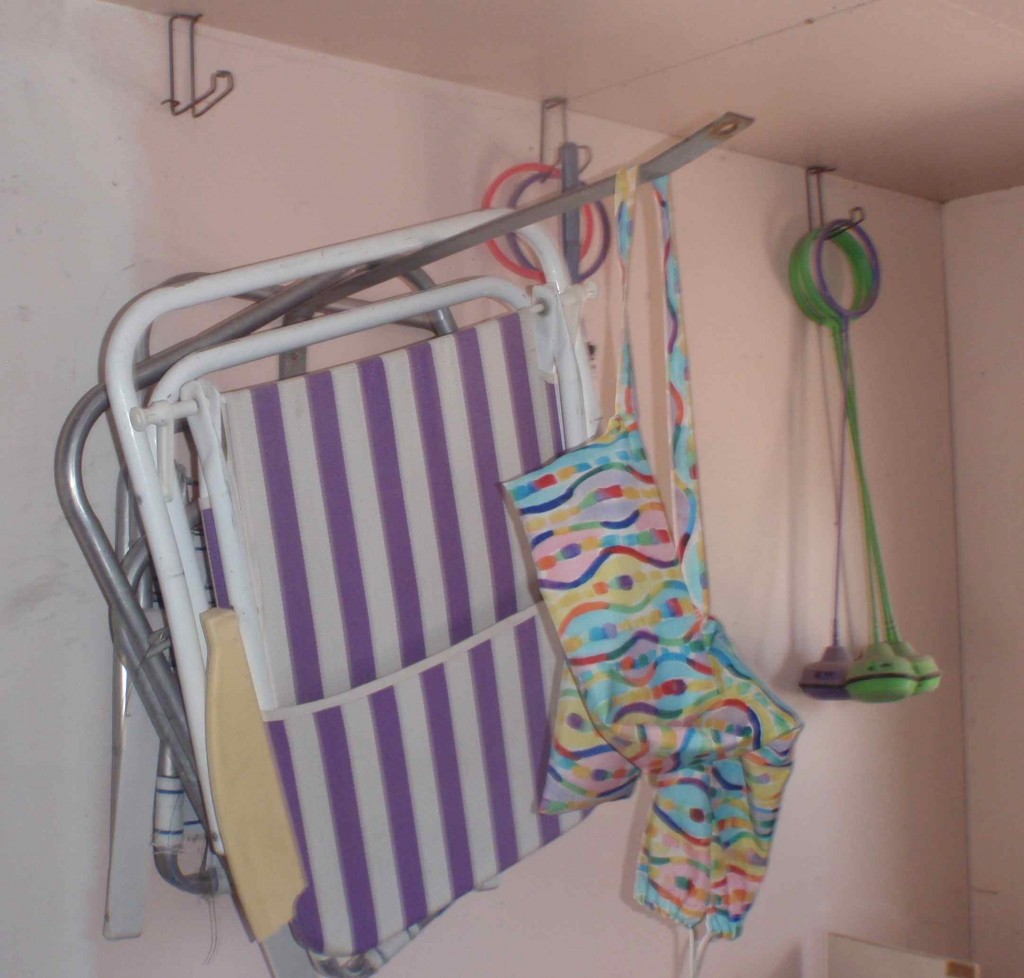 Junk yard hooks come in useful varieties for garage storage, like the long flat extension to store folding lawn chairs.